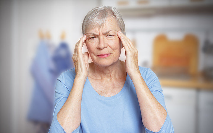 Elderly woman suffering from acute headache